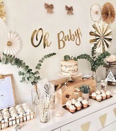 a baby shower party with cupcakes, cakes and decorations