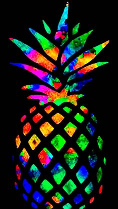 a colorful pineapple is shown in the dark