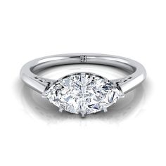 a round cut diamond engagement ring with three clawed shans on the band and shoulders