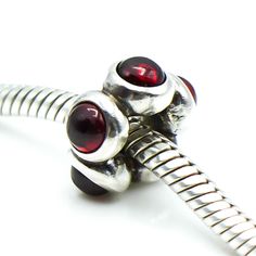 Authentic PANDORA Garnet Cabochon Sterling Silver Spacer Charm 790538GR - Retired. This beautiful sterling silver charm has a circle of five red Garnet cabochon gems that will add a touch of color to your bracelet. Red is the color of passion and draws attention like no other, radiating a strong and powerful energy that invokes us to take action. Garnet is the gemstone of health, passion and energy. It is said to help you feel grounded, secure and safe. It also makes a great birthday gift for somebody born in January. This item is retired from production and may be difficult to find. Charm is pre-owned and in great condition. Please view the photos for details, as they are part of the description.   All my jewelry items come in a black velvet jewelry pouch or gift box. Feel free to message Elegant Silver Beads And Gems For Gifts, Classic Silver Polished Cabochons, Classic Silver Cabochons With Polished Finish, Silver Jewelry With Cabochon Round Beads, Elegant Silver Cabochons For Gifts, Red Round Beads, Gems And Cabochons For Gifts, Silver Gemstone Cabochons For Gifts, Silver Round Cabochons With Polished Finish, Silver Beads Gems And Cabochons For Gifts