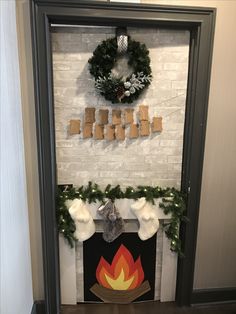 a fireplace decorated for christmas with stockings and wreaths