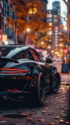 a black sports car is parked on the street