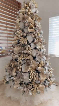 a christmas tree decorated with gold and silver ornaments