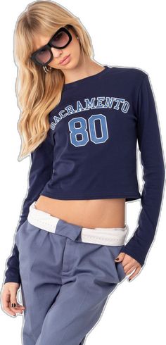 Blue Stretch Crew Neck T-shirt, Athleisure Tops For College In Spring, Spring Athleisure Tops For College, Fitted Athleisure Tops For College, Blue Crew Neck T-shirt For Sports Season, Varsity Tops For College Spring Season, Spring Varsity Tops For College, Varsity Tops For College In Spring, Collegiate Style Fitted Tops For Spring