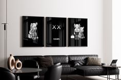 three black and white paintings hang on the wall above a leather couch in a modern living room