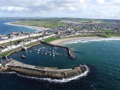 an aerial view of a harbor with boats in the water and buildings on the shore