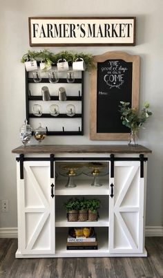 a white buffet table with shelves and potted plants