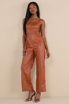 No one can come between you and an effortlessly cool look like the Lulus Trendiest Cutie Brown Vegan Leather Straight Leg Jumpsuit! Super sleek vegan leather shapes this stylish jumpsuit with wide adjustable straps, a straight neckline, and a seamed bodice with a decorative, covered button placket at the center. Belt loops accent the high, banded waist that sits atop straight, seamed pant legs with ankle-length hems. Smocked panel and hidden zipper/clasp at the back. Fit: This garment fits true Stylish Jumpsuit, Cool Look, Adhesive Bra, Straight Neckline, Strapless Bra, Covered Buttons, Vegan Friendly, Button Placket, Hidden Zipper