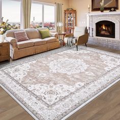 a living room filled with furniture and a large rug on top of a hard wood floor