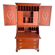 an antique wooden desk with drawers and cupboards