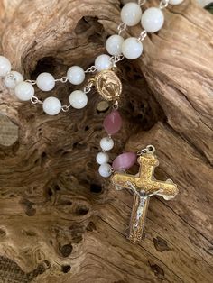 Hand picked with care to create a beautiful piece.  I love the gold with the light pink and white.  Such a purity and simple elegance to the rosary with a substantial weighted crucifix.  The "Our Father" beads are pink glass and the "Hail Mary" beads are white shell.  I always prefer the "Our Father" and "Hail Mary" beads to be a different shape or size so one can go into deep prayer with their eyes closed and know when they are at the next mystery by touch alone.  All parts are new on this rosa Hail Mary, Rosary Catholic, Simple Elegance, Pink Glass, Rosary, Bead Charms, Light Pink, Shells, Beauty Book