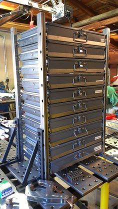 several metal drawers are stacked on top of each other in a room full of tools