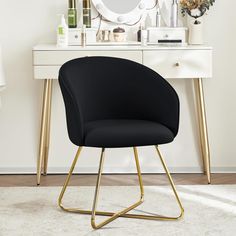 a black chair sitting in front of a white desk with a mirror on top of it