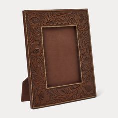 a brown leather frame sitting on top of a table