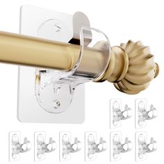 the curtain rod is attached to the glass door with brass colored handles and knobs