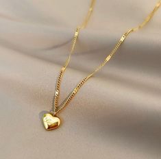 Are you looking for a gift for yourself or that significant person in your life? Look no further than the Gold Heart Necklace. Perfect to help you stand out in any environment. This necklace is a perfect addition to your wardrobe that's sure to make heads turn. Feel free to message us with any questions! Heart Charm Necklace For Gifts, Valentine's Day Heart Charm Locket Necklace For Anniversary, Heart Pendant Necklace Wedding Gift, Heart Necklace For Wedding Gift, Heart Shaped Necklace For Wedding Gift, Dainty Locket Necklace For Valentine's Day Anniversary, Heart Pendant Locket Necklace For Valentine's Anniversary, Heart Cut Locket Necklace For Valentine's Day, Heart Shaped Necklace For Anniversary Gift