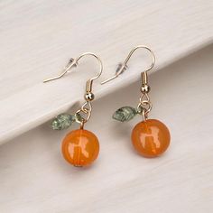 Did you hear what's right in style and trending this season?   Fruit themed jewelry!  These earrings feature a full orange (a bead) and a tiny green leaf charm on each earring. Thanks for visiting ❤️ Beaded Fruit Jewelry, Fruit Resin, Earrings Food, Kawaii Fruit, Earrings Kawaii, Fruit Jewelry, Fruit Earrings, Orange Earrings, Orange Fruit