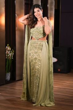 Green lehenga with all over hand embroidery work using pearls, sequins and crystals in floral pattern. Paired with a padded blouse with floral hand embroidery and embroidered cape sleeves. - Aza Fashions Hand Embellished Party Wear Sharara For Reception, Bollywood Style Hand Embellished Saree Sets, Diwali Hand Embellished Chinon Sets, Hand Embellished Chinon Lehenga Floor-length, Hand Embellished Floor-length Chinon Lehenga, Hand Embellished Saree Set For Party Wear, Floor-length Hand Embellished Choli For Parties, Semi-stitched Hand Embellished Chinon Lehenga, Hand Embellished Party Wear Saree Set