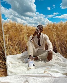 a man sitting in front of a mirror taking a selfie with his cell phone