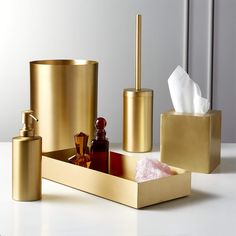 gold bathroom accessories on a white counter top