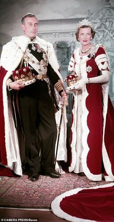 an old photo of two people dressed in period clothing and tiaras standing next to each other