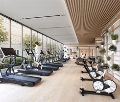 there are many treadmills lined up in the gym with plants growing on them