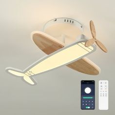 a ceiling fan and remote control with an airplane shaped light on it's side