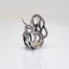 A sculptural piece inspired by microscopic forms, the Myth Ring explores the beauty and mystery of life. An edgy statement ring that is playful, flirtatious, and moody. The ring's open design can accommodate sizes 7 to 8.5. One-of-a-Kind Size 7. Adjustable up to size 8.5 Sterling Silver To get your ring size, click here for our Ring Sizing Form. Learn about the energetic properties of the metals or gemstones in this design here In-stock and Ready-to-Ship items ship within a 2-3 day process. Modern Twist Jewelry Ring With Unique Design, Unique Hand Cast Snake Ring As Gift, Unique Metal Snake Ring With Open Design, Unique Hand Cast Snake Ring Gift, Unique Metal Open Snake Ring, Adjustable Unique Snake Ring, Unique Metal Rings With Open Band, Unique Metal Open Band Rings, Unique Open Band Metal Rings