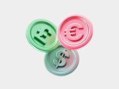 three plastic buttons with the letter e and dollar signs on them, all in different colors