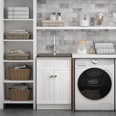 a washer and dryer sitting next to each other in a room with shelves