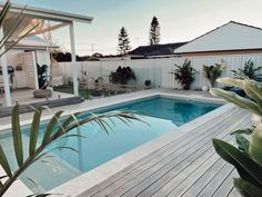 a backyard with a pool and decking area