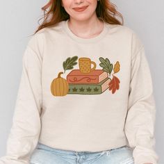 Cozy up with a good book and this sweatshirt!  Details:  - Gildan 18000 Sweatshirt - Unisex fit, but I prefer to size up for a more oversized fit - Pre-shrunk medium weight sweatshirt - DTG printing (not vinyl that will peel off) - Ships within 2-7 business days  Please note: your item will be shipped from the manufacturer. Bookish Crew Neck Sweatshirt For Winter, Bookish Cotton Sweatshirt For Winter, Winter Bookish Cotton Sweatshirt, Winter Cotton Sweatshirt, Comfy Fall Outfits, Sweatshirt Details, Fall Reading, Cozy Fall Outfits, Fallen Book