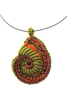 a beaded necklace with an orange and green spiral design