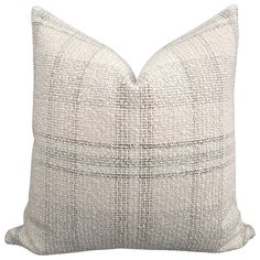 a gray and white pillow on a white background