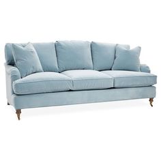 a blue couch sitting on top of a white floor