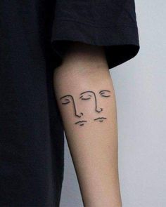 a person with a face tattoo on their arm