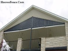 the front of a house with an attached balcony