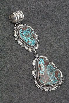 This stunning Egyptian turquoise and sterling silver pendant was made by Navajo silversmith Raymond Delgarito. The back is signed RD and stamped sterling.Length: 5 1/2"Width: 2 1/4"Free shipping on all orders! We ship with USPS and always include tracking. All orders ship within a day of payment.Returns are accepted up to 30 days after you receive your order. Just send us a message. Our shop offers cash back or store credit. The item must be returned in the same condition. Western Style Collectible Turquoise Sterling Silver Necklace, Southwestern Turquoise Pendant Necklace, Southwestern Untreated Turquoise Collectible Necklace, Southwestern Style Turquoise Pendant Necklace, Collectible Southwestern Turquoise Pendant Necklace, Southwestern Turquoise Sterling Silver Collectible Necklace, Southwestern Sterling Silver Turquoise Necklace Collectible, Southwestern Sterling Silver Turquoise Concho Necklace, Egyptian Turquoise