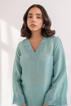 Tiffany blue kurta crafted in upada silk with flared sleeves and resham cutwork embroidery on the neckline, sleeves, front slits.
Components: 2
Pattern: Embroidered
Type Of Work: Resham
Neckline: V Neck
Sleeve Type: Flared
Fabric: Upada Silk
Color: Blue
Other Details: 
Side slits
Length:
Kurta: 44 inches
Pant: 36 inches
Closure:
Pant: Elastic band in the back
Occasion: Puja - Aza Fashions V Neck Kurta, Blue Kurta, Cutwork Embroidery, Cut Work, Tiffany Blue, Pant Set, Embroidered Silk, Set For Women, Flared Sleeves