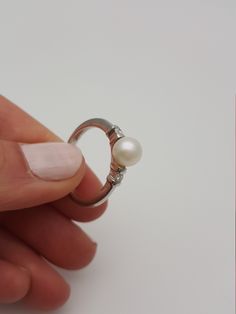 This elegant and timeless pearl and diamond white gold ring is a must-have in a woman's wardrobe. It goes perfectly with almost anything Beautiful real Japanese pearl and real diamonds The pearls is white, smooth and shiny with high luster White and clean diamonds H/VS Hand made * genuine Japanese Akoya cultured pearl * 6.6 mm in diameter * round in shape * very high luster * grade AAA * 18K White gold * 0.10 carats total weight of real diamonds * quality H color VS clarity * ring made in Italy Classic Brilliant Cut Diamond White Pearl Ring, Timeless Pearl Ring With Brilliant Cut For Wedding, Timeless Diamond White Brilliant Cut Pearl Ring, Classic White Gold Pearl Ring With Diamond Accents, Timeless Diamond White Pearl Ring With Brilliant Cut, Timeless Brilliant Cut Pearl Wedding Ring, Timeless Pearl Wedding Ring With Brilliant Cut, Timeless Wedding Pearl Ring With Brilliant Cut, Classic White Gold Akoya Pearl Ring