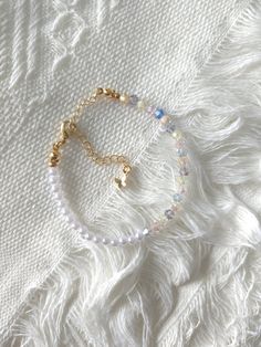 FOR OTHER DAINTY BEADED BRACELETS: https://www.etsy.com/ca/shop/ArtiChouXCanada?ref=seller-platform-mcnav%C2%A7ion_id&section_id=46088511 Bracelet Length: 13-19cm (5.1-7.4 inches) with a 14k gold filled extender.  This bracelet features an assortment of crystals and faux pearls.  Thread may be visible since it is a handmade product   SIZING  Wrap a soft measuring tape snugly around the widest part of your wrist. Add 1.27cm (0.5in) to that measurement to determine the right bracelet size.  MATERI Minimalist White Bangle Chain Bracelet, Minimalist Adjustable White Chain Bracelet, Delicate White Adjustable Crystal Bracelet, Dainty White Bangle Charm Bracelet, Minimalist White Adjustable Chain Bracelet, Minimalist Adjustable White Charm Bracelet, Delicate White Adjustable Chain Bracelet, Handmade Minimalist Crystal Bracelet, Handmade Adjustable White Chain Bracelet