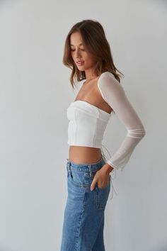 So trendy in the Rio Corset Shrug Set! This corset top is complete with a strapless fold over neckline, a lace up back with silver grommets, and a mesh long sleeve shrug. Available in black and white. Pair with your favorite jeans to complete the look! Details Top self: 95% Nylon, 5% Spandex Top lining 92% Polyester, 8% Spandex Shrug self: 90%, Nylon, 10% Spandex Shrug lining: 92% Polyester, 8% Spandex Item sold as set Silicon grips Boning Material has some stretch Machine wash cold / Tumble dry Long Sleeve Shrug, Sleeve Shrug, American Threads, Spandex Top, Mesh Long Sleeve, Ruffled Maxi Dress, Lace Ruffle, Sweater Sale, Bodycon Mini Dress