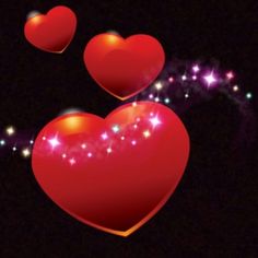 three red heart shaped balloons floating in the air with sparkles and stars around them