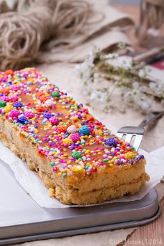 a piece of cake with sprinkles on it