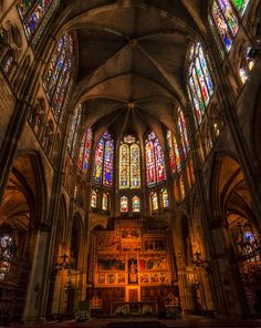 the inside of an old church with stained glass windows