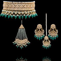 This regal set befitting a queen's closet, pays tribute to Mughal royalty and is the classiest way to embrace the festive season! A charmingly curated set, intricately detailed with the rich emerald drops and garnished with lush CZ and faux pearl beads. Approximate earrings length is. This set is available in 3 options: Necklace + Earrings Necklace + Earrings + Teekah Necklace + Earrings + Teekah + Jhoomar Please select the desired option at the time of purchase. Gold-plated on high-quality brass as the base metal. Made by order. Kindly allow 7-8 weeks for the delivery of this item. For custom or urgent requests, please contact support@alacouture.com. *Please Note: We use faux stones and beads in all of our jewelry.