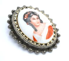 For your consideration, Serendipity Treasures present this vintage Limoges Cameo brooch It consists of a painted Limoge ceramic porcelain of women in a red dress.It is surrounded by small seed faux pearls and studs in a brass gold setting. it has a bale so cana pendant to be made into a necklace the back porcelain is marked made in France Limoges The dimensions of this cameo pin is 2 inches x 1 1/2inch. the cameo is in beautiful condition. the gold plated metal is in great condition. the pearls Victorian Style Enamel Pin Gift, Victorian White Cabochon Brooches, White Victorian Cabochon Brooches, White Vintage Cabochon Brooches, Beaded Pendants, Victorian Revival, Female Profile, Ceramic Porcelain, Cameo Brooch