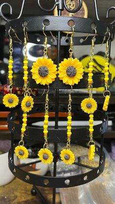 Discover the essence of summer with our handcrafted Sunflower Earrings, a delightful accessory for any sun-loving soul. Made with hypoallergenic materials, these earrings ensure comfort for all-day wear. The vibrant yellow petals and intricate details mirror the warmth and joy of a sunlit day. Lightweight and playful, the dangle design adds a whimsical touch to both casual and dressy outfits. Perfect for those with sensitive skin, our earrings provide an eye-catching bloom without the worry. Let Summer Gift Jewelry With Sunflower Design, Bohemian Summer Jewelry In Flower Shape, Sunflower Design Dangle Earrings As Gift, Sunflower Design Dangle Earrings For Gift, Summer Flower-shaped Beaded Jewelry, Summer Beaded Flower-shaped Jewelry, Yellow Sunflower Design Dangle Earrings, Bohemian Sunflower Design Jewelry For Summer, Bohemian Sunflower Design Summer Jewelry