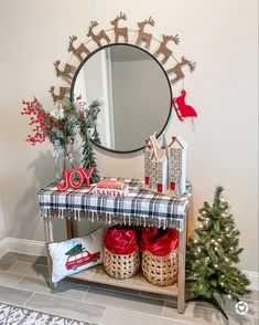 a decorated entryway with christmas decorations and gifts under a mirror on the side table