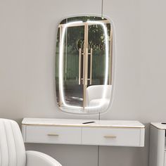 a white desk with a mirror and chair